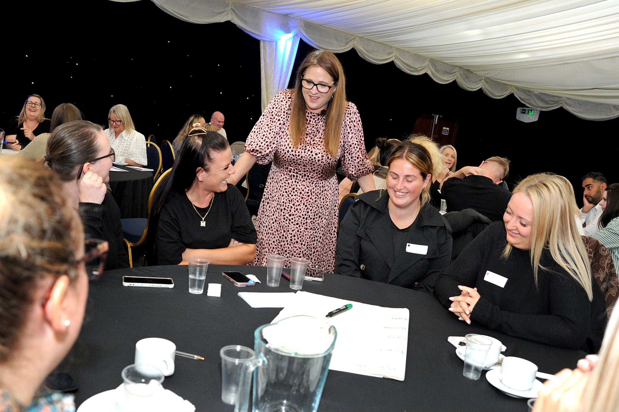 Jess Pressland standing at a table while facilitating a group session