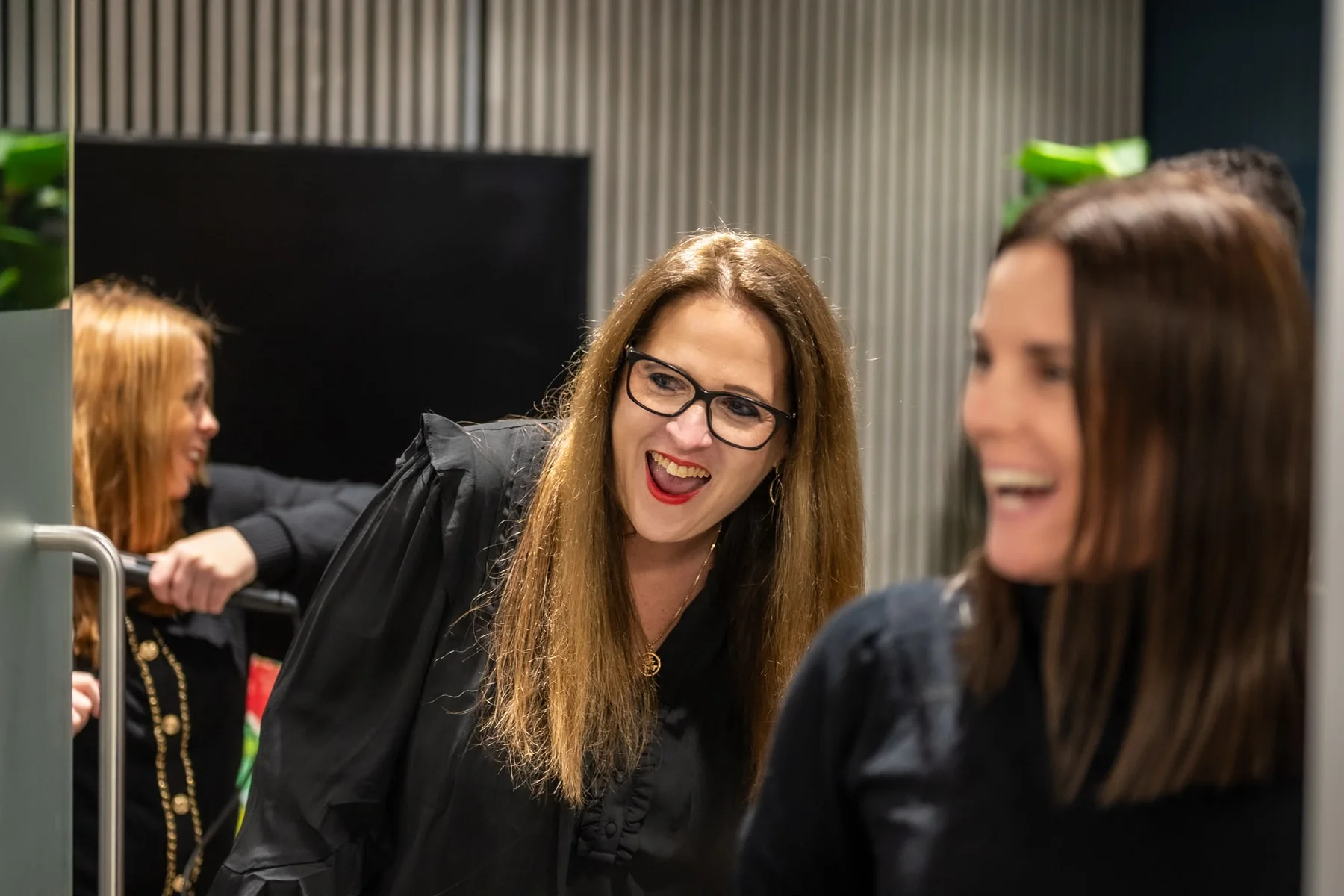 Jess laughing with guests at an event