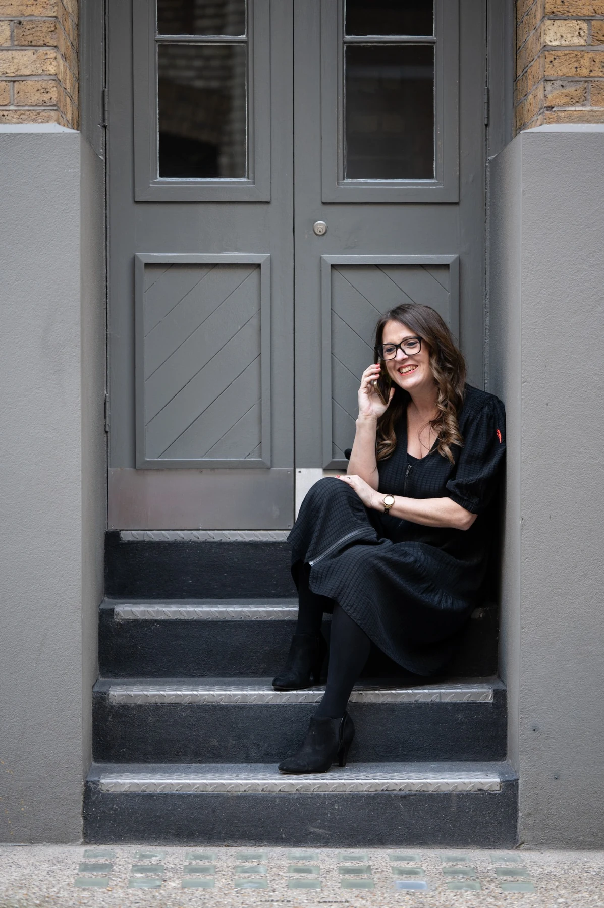Jess seated on steps during a professional portrait shoot